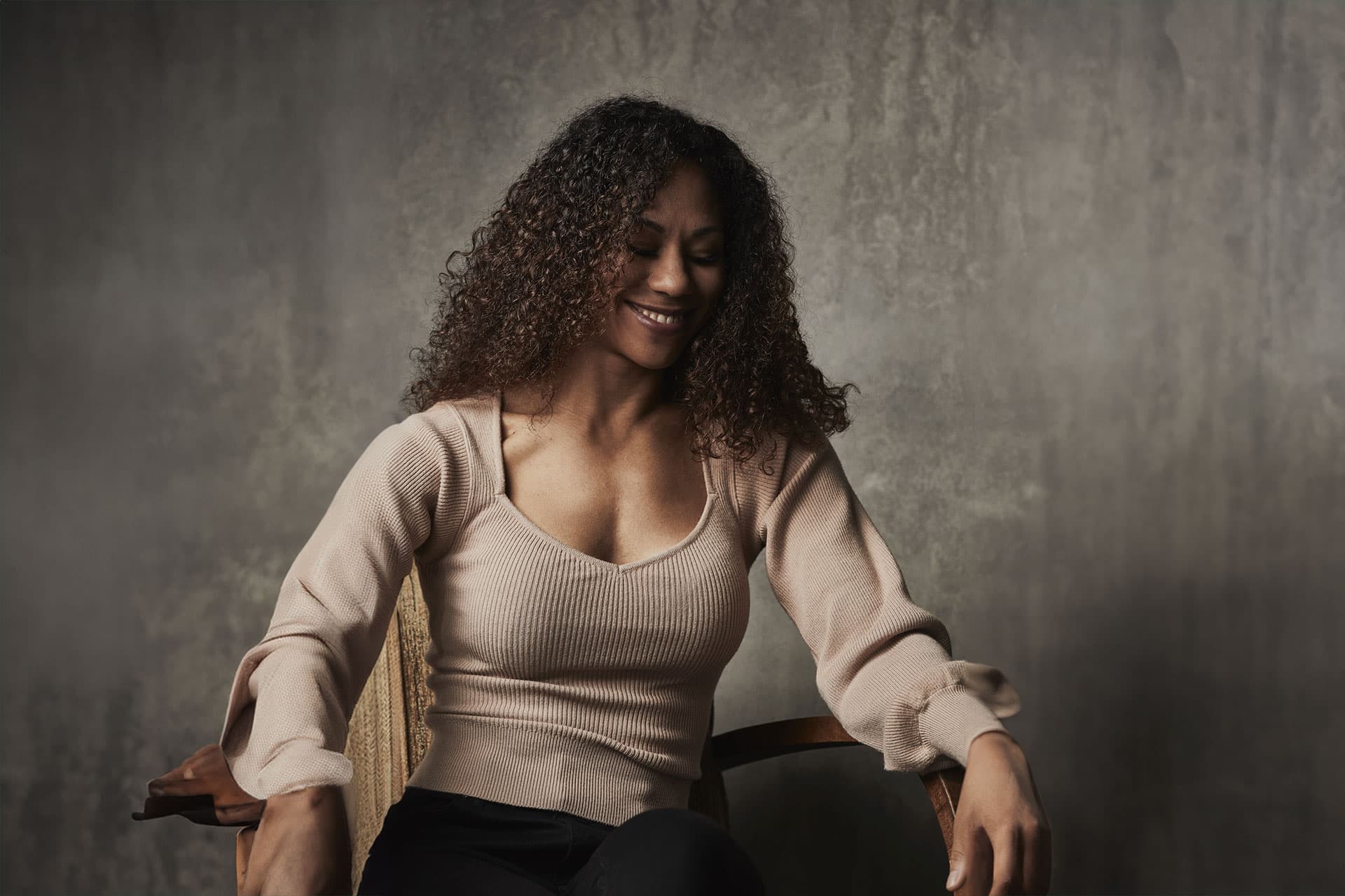 A woman sitting on a chair.