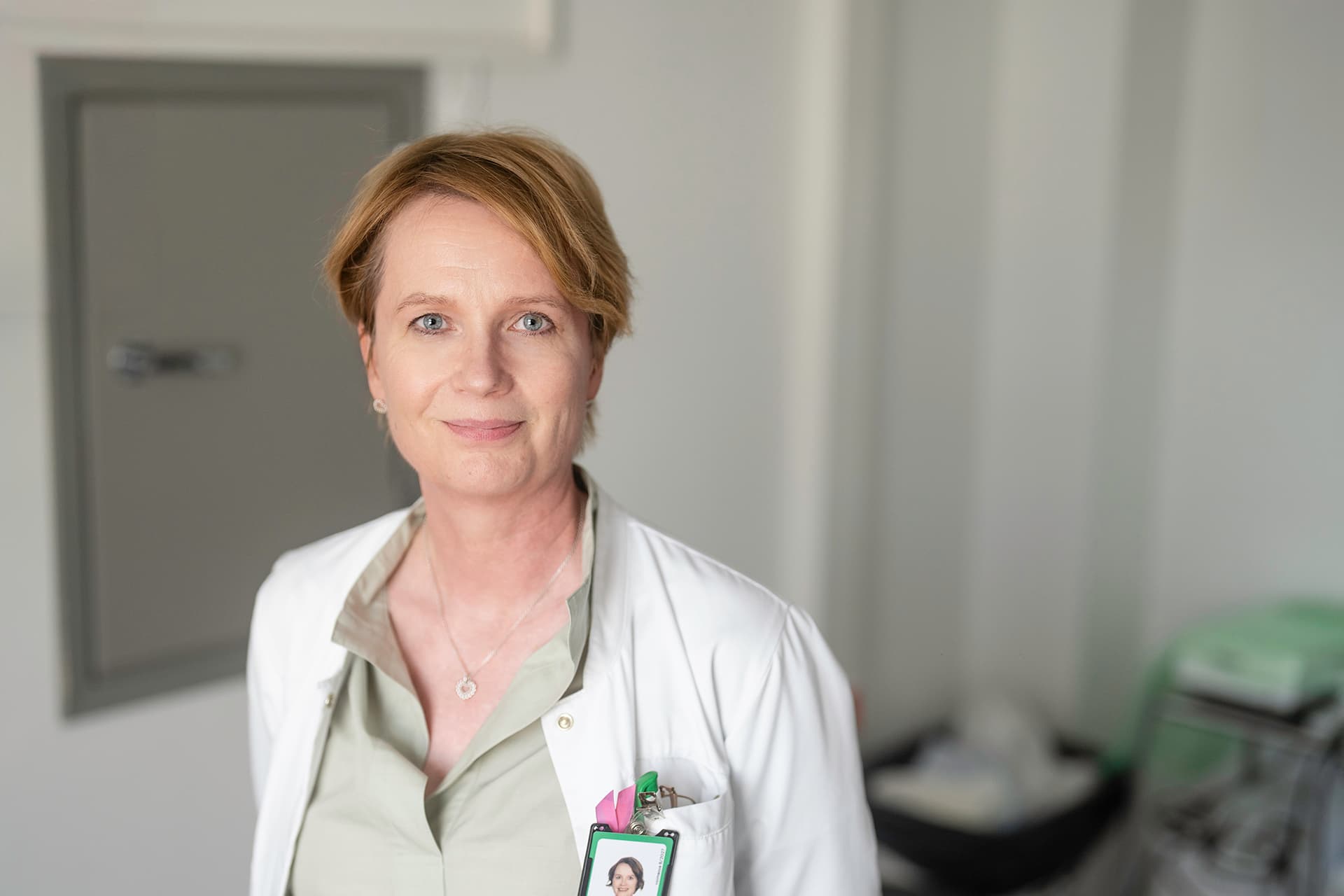 A doctor at Mehiläinen wearing a doctor's coat, ready to examine a patient.
