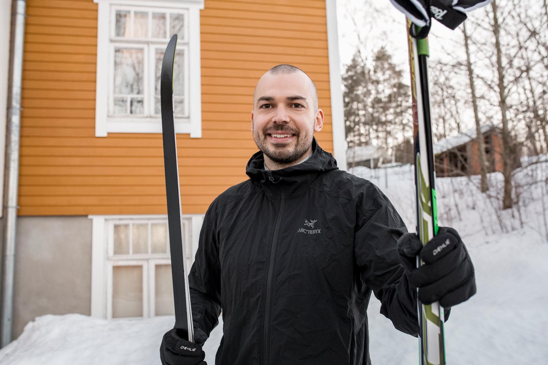 man outside with skis